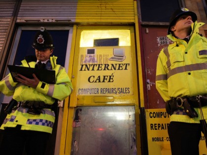 MANCHESTER, ENGLAND - APRIL 08: Police officers guard an internet cafe on Cheetham Hill Road after anti-terror raids across the North West today on April 8, 2009 in Manchester, England. Ten men have been arrested in a major counter terrorism operation across the UK. (Photo by Christopher Furlong/Getty Images)