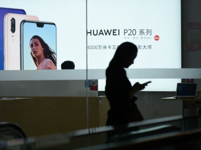 A Huawei poster is displayed in a Huawei store in Beijing on August 7, 2018. - Despite being essentially barred from the critical US market, Huawei surpassed Apple to become the world's number two smartphone maker in the second quarter of this year and has market leader Samsung in its …