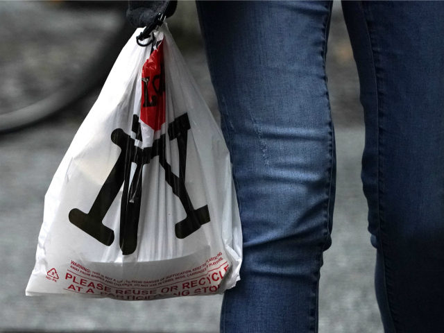 A person with their lunch in a plastic bags walks in midtown in New York on February 28, 2