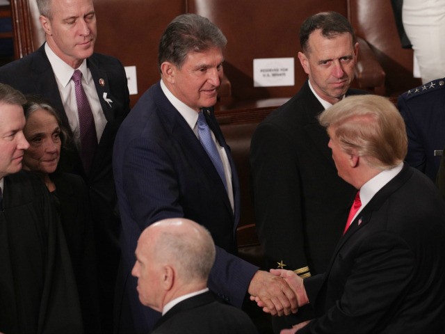President Donald Trump greets Joe Manchin (D-WV) after the State of the Union address in the chamber of the U.S. House of Representatives at the U.S. Capitol Building on February 5, 2019 in Washington, DC. President Trump's second State of the Union address was postponed one week due to the …