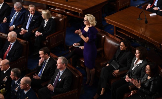 US Senator Kyrsten Sinema (D-AZ) claps during the State of the Union address at the US Cap