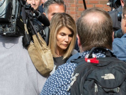 Actress Lori Loughlin (C) and husband Mossimo Giannulli (C rear) exit the Boston Federal C