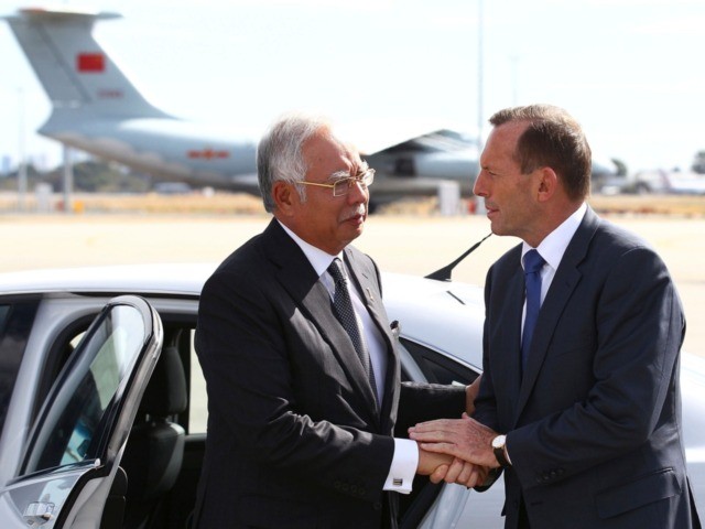 Australian Prime Minister Tony Abbott, right, shakes hands with his Malaysian counterpart Najib Razak as Razak prepares to depart Australia after his visit during the search of the missing Malaysia Airlines flight MH370 at Perth International Airport, Australia, Thursday, April 3, 2014. Najib arrived at the Australian air force base …