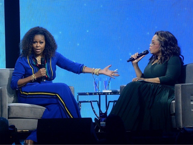 Michelle Obama, left, and Oprah Winfrey speak onstage at "Oprah's 2020 Vision: Y
