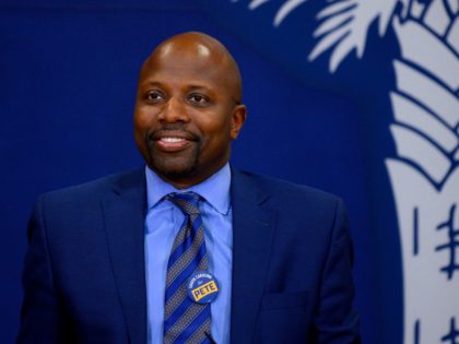 Former Special Assistant to President Barack Obama, Reggie Love (L), looks on as Democrati