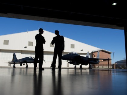 Pilots with the US Air Force stand inside a hangar alongside a F-15 fighter jet and a T-38 Talon trainer jet during the inaugural Trilateral Exercise between the US Air Force, United Kingdom's Royal Air Force and the French Air Force at Joint Base Langley-Eustis in Hampton, Virginia, December 15, …