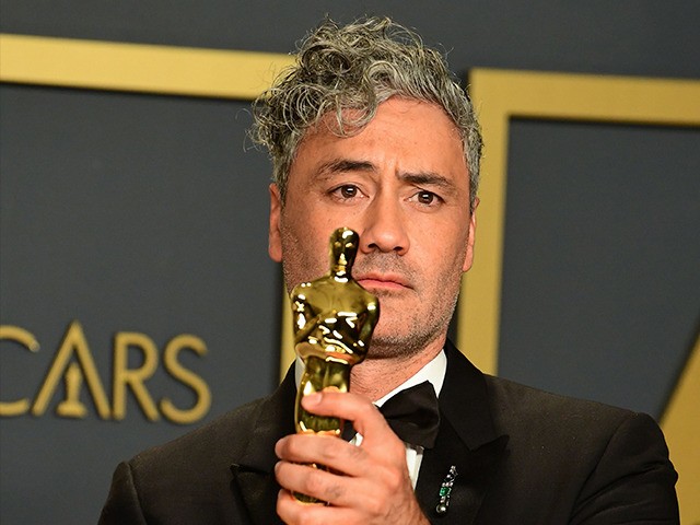 New Zealand director Taika Waititi poses in the press room with the Oscar for Best Adapted