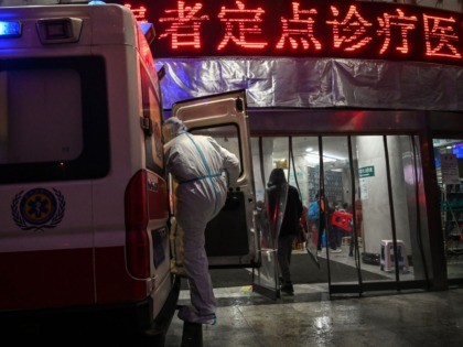 A medical staff member wearing protective clothing to help stop the spread of a deadly virus which began in the city, is seen on a ambulance at the Wuhan Red Cross Hospital in Wuhan on January 25, 2020. - The Chinese army deployed medical specialists on January 25 to the …
