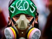 A masked demonstrator takes part in a global youth climate action strike in Buenos Aires, on September 27, 2019, at the end of a global climate change week. (Photo by RONALDO SCHEMIDT / AFP) (Photo credit should read RONALDO SCHEMIDT/AFP via Getty Images)