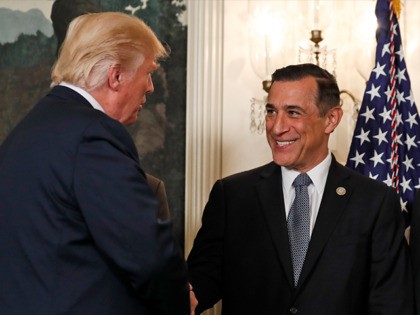President Donald Trump, left, greets Rep. Darrell Issa, R-Calif., in the Diplomatic Reception Room of the White House in Washington, Monday, Aug. 14, 2017, before an event to sign a memorandum calling for a trade investigation of China. (AP Photo/Alex Brandon)
