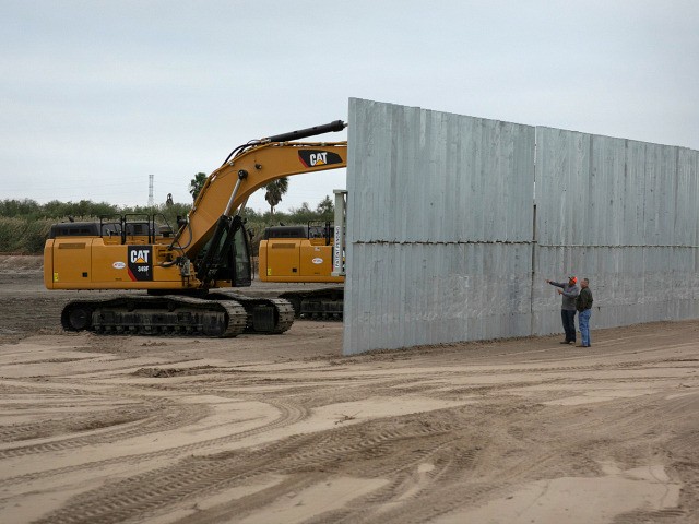 MISSION, TEXAS - DECEMBER 11: A construction crew works on a section of privately built border wall on December 11, 2019 near Mission, Texas. The hardline immigration group We Build The Wall is funding the construction of the wall on private land along a stretch of the Rio Grande, which …