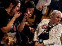 DES MOINES, IA - FEBRUARY 03: A woman with her dog applies lipstick as she attends Democratic presidential candidate former Vice President Joe Biden's Iowa caucus night event at Drake University on February 3, 2020 in Des Moines, Iowa. Iowa is the first contest in the 2020 presidential nominating process …