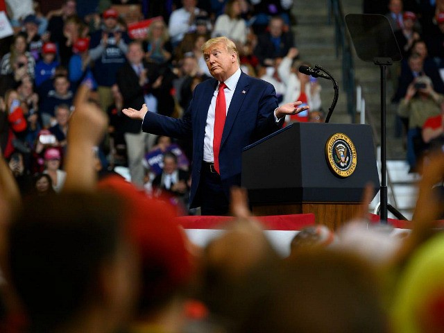 US President Donald Trump looks at his supporters after reading words from Al Wilson's song "The Snake" during a rally in Manchester, New Hampshire on February 10, 2020. (Photo by JIM WATSON / AFP) (Photo by JIM WATSON/AFP via Getty Images)