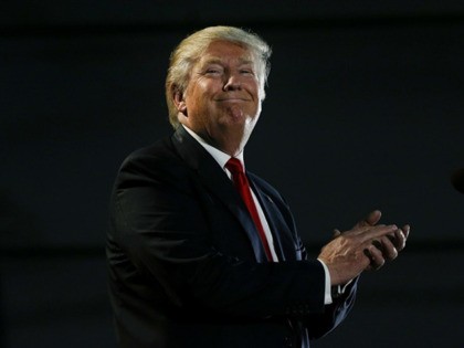 Republican presidential candidate Donald Trump smiles while speaking during a rally in San