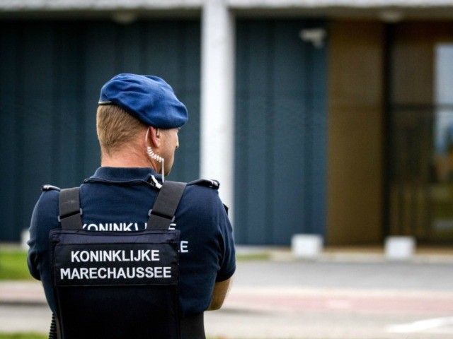 A police officer stands outside the extra secure court in Schiphol, where the hearing in t