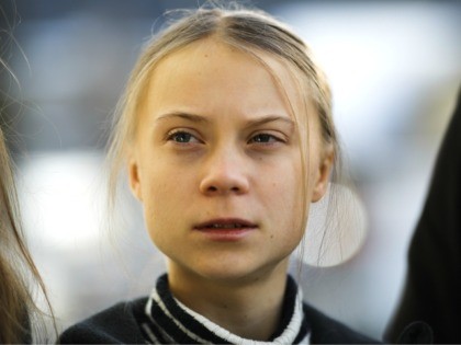 Swedish climate activist Greta Thunberg poses for media as she arrives for a news conferen