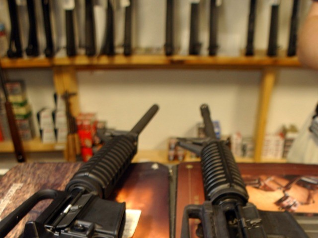 DENVER - SEPTEMBER 13: Two Colt AR-15's, both now legal, sit on the counter of Dave's Guns September 13, 2004 in Denver, Colorado. The weapon on the right has a bayonet mount, flash suppressor and a collapsible stock, the gun on the left does not. Between 1994 and September 13, …