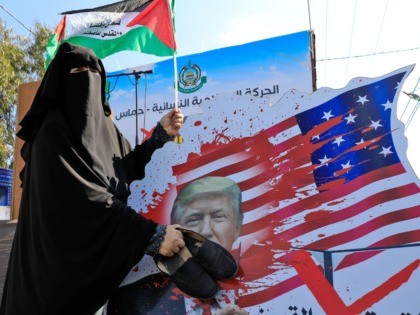 A Palestinian woman slams with her shoes a portrait of US President Donald Trump during a demonstration by women supporters of the Hamas movement, against the US Middle East peace plan, in Gaza City on February 5, 2020. (Photo by Emmanuel DUNAND / AFP) (Photo by EMMANUEL DUNAND/AFP via Getty …