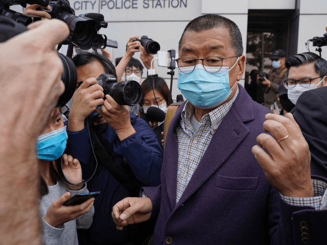 Founder of Hong Kong's Apple Daily newspaper, Jimmy Lai, walks out from a police station a