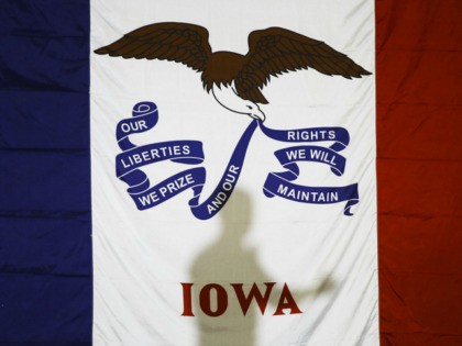 Democratic presidential candidate former South Bend, Ind., Mayor Pete Buttigieg's shadow is cast on the Iowas state flag as he speaks during a campaign event at Northwest Junior High, Sunday, Feb. 2, 2020, in Coralville, Iowa. (AP Photo/Matt Rourke)