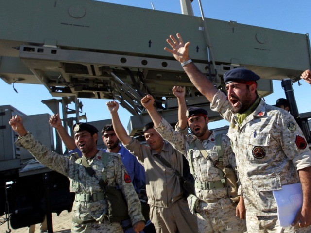 Iranian navy personnel celebrate after successfully launching a Ghader missile from the Jask port area on the shores of the Sea of Oman during a drill, Tuesday, Jan. 1, 2013. Iran says it has tested advanced anti-ship missiles in the final day of a naval drill near the strategic Strait …