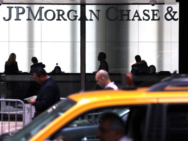 NEW YORK, NY - OCTOBER 02: People pass a sign for JPMorgan Chase & Co. at it's headquarter