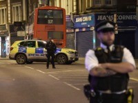 A police officer stands guard near the scene after a stabbing incident in Streatham London, England, Sunday, Feb. 2, 2020. London police officers shot and killed a suspect after at least two people were stabbed Sunday in what authorities are investigating as a terror attack. (AP Photo/Alberto Pezzali)