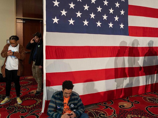 Young supporters check their phones as they attend the Caucus Night Celebration event for Democratic presidential candidate Vermont Senator Bernie Sanders in Des Moines, Iowa, on February 3, 2020. (Photo by kerem yucel / AFP) (Photo by KEREM YUCEL/AFP via Getty Images)