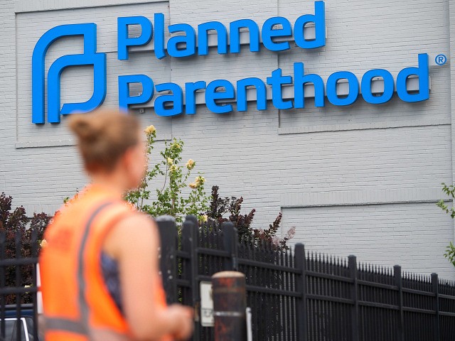 A demonstrator stands outside the Planned Parenthood Reproductive Health Services Center i
