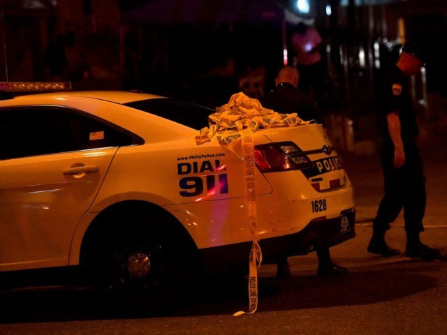 PHILADELPHIA, PA - AUGUST 14: Yellow police tape drapes from a vehicle as police respond t