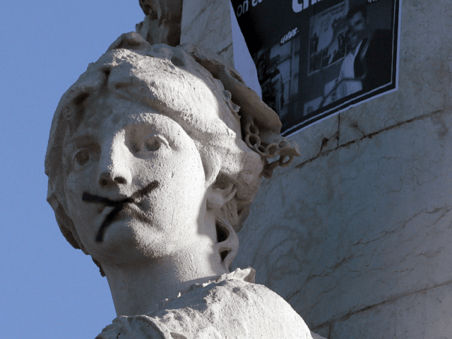 A black X is put across the mouth of a relief adoring the plinth of the statue of Marianne at the Place de la Republique, on January 11, 2015 in Paris, prior to the start of a huge march which will end at the Place de la Nation. More than …