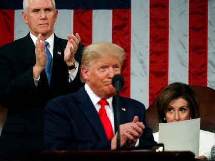 WASHINGTON, DC - FEBRUARY 04: U.S. Vice President Mike Pence applauds as House Speaker Nancy Pelosi remains seated during U.S. President Donald Trump's State of the Union address in the House chamber on February 4, 2020 in Washington, DC. Trump is delivering his third State of the Union address on …
