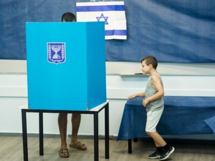 ROSH HAAYIN, ISRAEL - SEPTEMBER 17: An Israeli man and his son casts his vote on September