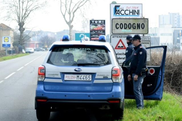 Italian police closed off 11 northern towns in a bid to stem the spread of COVID-19 Cigarettes, a few jokes on offer at Italy's quarantine checkpoints
