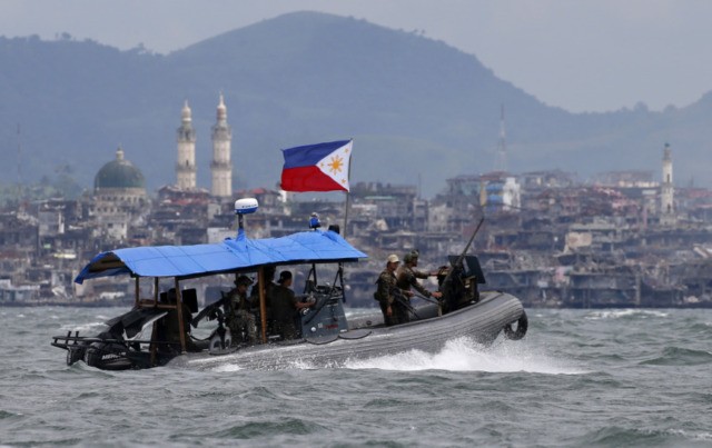 Trump Philippines Fact Check In this Oct. 19, 2017, file photo, Philippine Navy commandos aboard a gunboat patrol the periphery of Lake Lanao as smoke rises from the "Main Battle Area" where pro Islamic group militants made a final stand amid a massive military offensive of Marawi city in southern Philippines. President Donald Trump contended this week that the United States saved the Philippines from Islamic State terrorism. His assertion vastly overstated both the threat IS posed to the country and what the U.S. did about it. (AP Photo/Bullit Marquez, File) The Associated Press