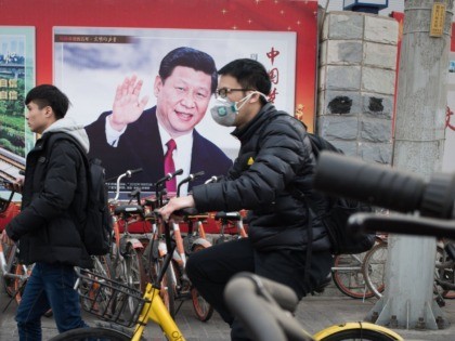 A propaganda poster showing China's President Xi Jinping is pictured on a wall in Beijing on March 12, 2018. China's Xi Jinping on March 11 secured a path to rule indefinitely as parliament abolished presidential term limits, handing him almost total authority to pursue a vision of transforming the nation …