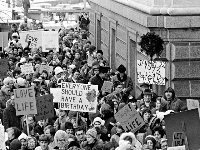 An estimated 5,000 people, women and men, march around the Minnesota Capitol building protesting the U.S. Supreme Court's Roe v. Wade decision, ruling against state laws that criminalize abortion, in St. Paul, Minn., Jan. 22, 1973. The marchers formed a "ring of life" around the building. (AP Photo)