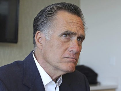 Sen. Mitt Romney, R-Utah, listens to reporters following a roundtable discussion at Interm