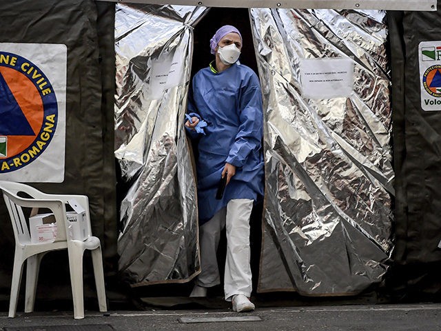 A paramedic wearing a mask gets out of a tent set up by the Italian Civil Protection outside the emergency ward of the Piacenza hospital, northern Italy, Thursday, Feb. 27, 2020. Italy is changing how it reports coronavirus cases and who will get tested in ways that could lower the …