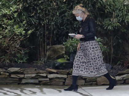 A worker at the Life Care Center in Kirkland, Wash., near Seattle, wears a mask as she wal