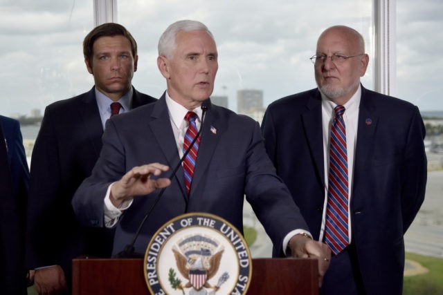 Vice President Mike Pence, center, along with Florida Gov. Ron DeSantis, left, and CDC Dir