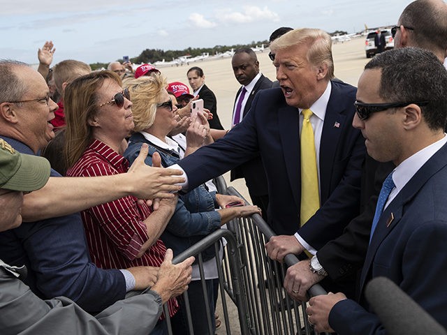 President Donald Trump shakes hands with supporters upon arrival at the Orlando Sanford International Airport, Monday, March 9, 2020 in Orlando, Fla. (AP Photo/Alex Brandon)
