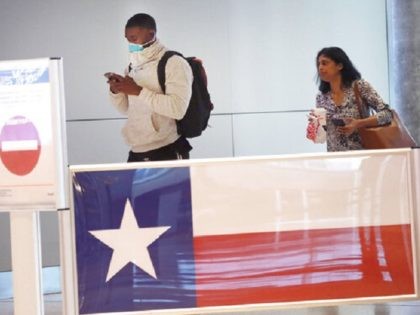 Travelers make their way through Love Field airport in Dallas, Thursday, March 12, 2020. (AP Photo/LM Otero)