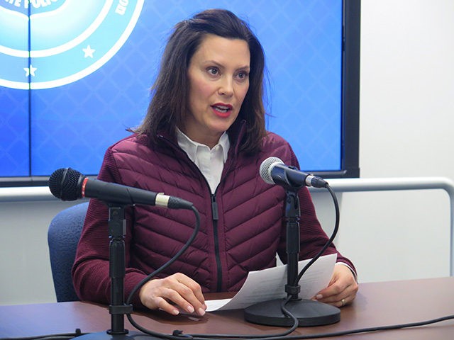 FILE - In this Tuesday, March 10, 2020, file photo, Michigan Gov. Gretchen Whitmer announces the state's first two cases of coronavirus, at the Michigan State Police headquarters in Windsor Township, Mich. Coronavirus cases in Michigan rose sharply late Thursday, March 12, 2020, as officials announced more cases, and as …