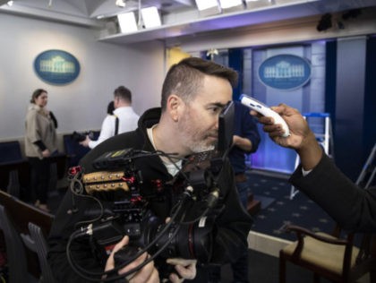 A member of the media gets their temperature taken over concerns about the coronavirus in the James Brady Briefing Room at the White House, Saturday, March 14, 2020, in Washington. The White House announced Saturday that it is now conducting temperature checks on anyone who is in close contact with …