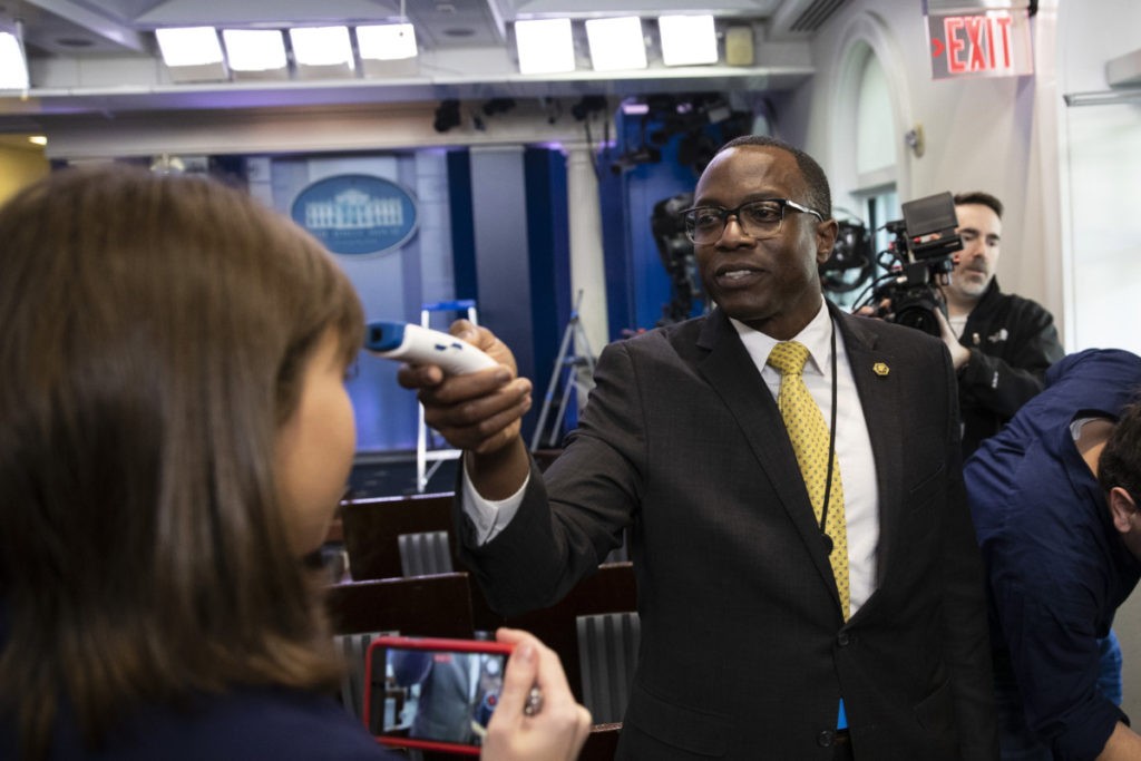 A member of the media gets their temperature taken over concerns about the coronavirus in the James Brady Briefing Room at the White House, Saturday, March 14, 2020, in Washington. The White House announced Saturday that it is now conducting temperature checks on anyone who is in close contact with President Donald Trump and Vice President Mike Pence. The vast majority of people recover from the new coronavirus. According to the World Health Organization, most people recover in about two to six weeks, depending on the severity of the illness.(AP Photo/Alex Brandon)