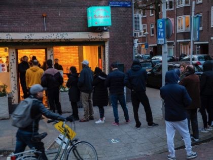 People queue to buy marijuana at coffeeshop Bulwackie in Amsterdam, Netherlands, Sunday, March 15, 2020, after a TV address of health minister Bruno Bruins who ordered all Dutch schools, cafes, restaurants, coffeeshops and sport clubs to be closed on Sunday as the government sought to prevent the further spread of …