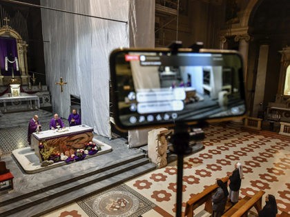 The Holy Mass is celebrated in an empty church and broadcasted in streaming online for the faithful in the San Luigi Gonzaga Parrish church in Milan, Italy, Sunday, March 15, 2020. For most people, the new coronavirus causes only mild or moderate symptoms. For some, it can cause more severe …