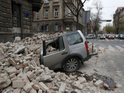 A car is crushed by falling debris after an earthquake in Zagreb, Croatia, Sunday, March 22, 2020. A strong earthquake shook Croatia and its capital on Sunday, causing widespread damage and panic. (AP Photo/Darko Bandic)