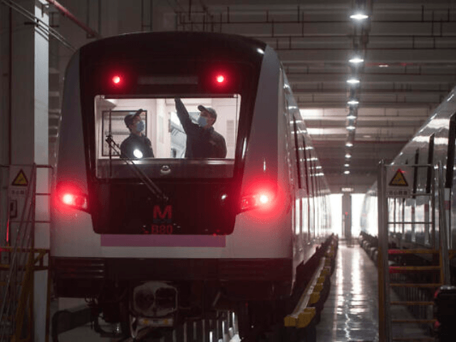 In this March 23, 2020 photo released by Xinhua News Agency, workers prepares a subway tra